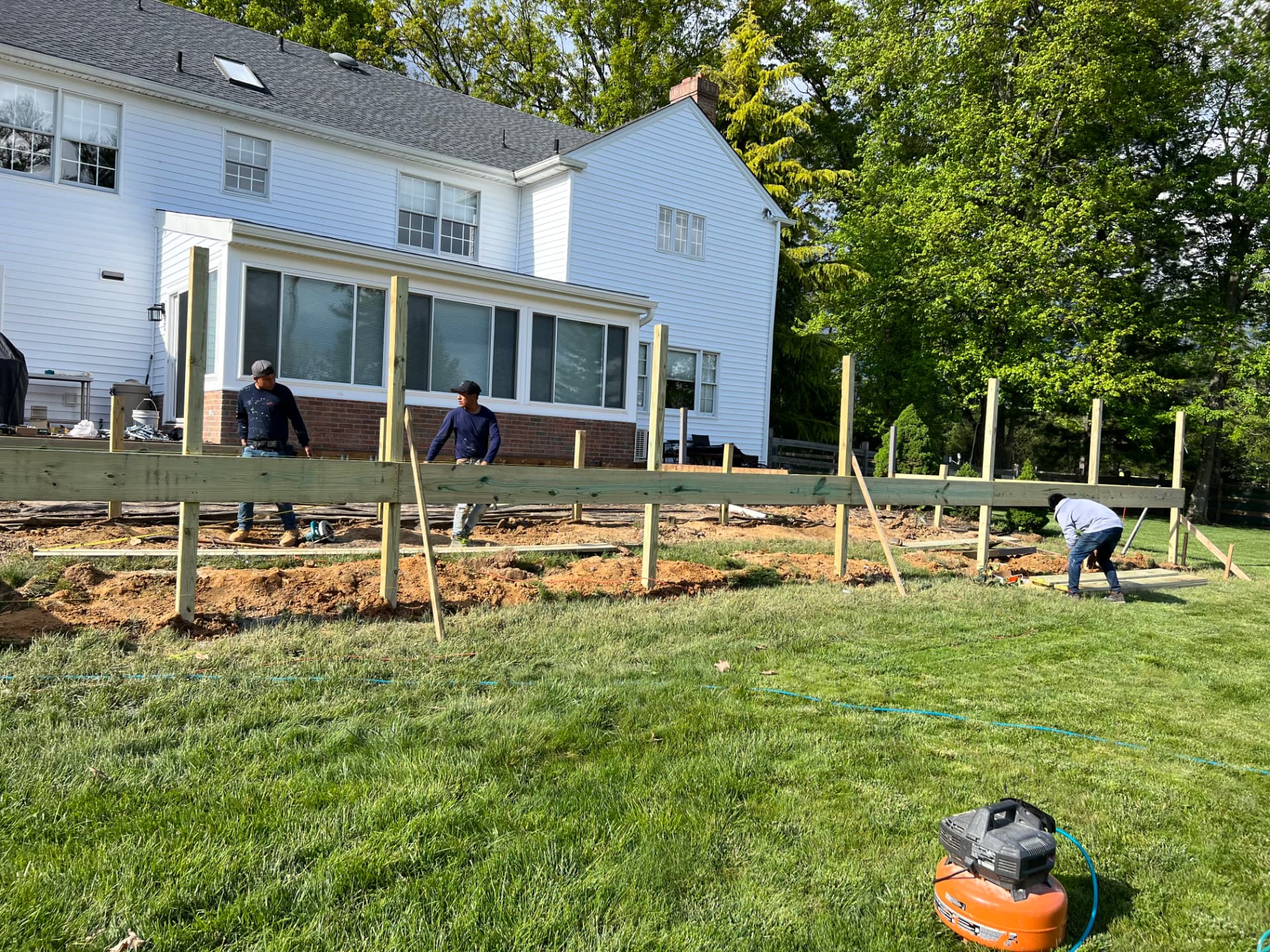 Deck posts and beams being installed during deck construction by Juan Resendiz Contractor