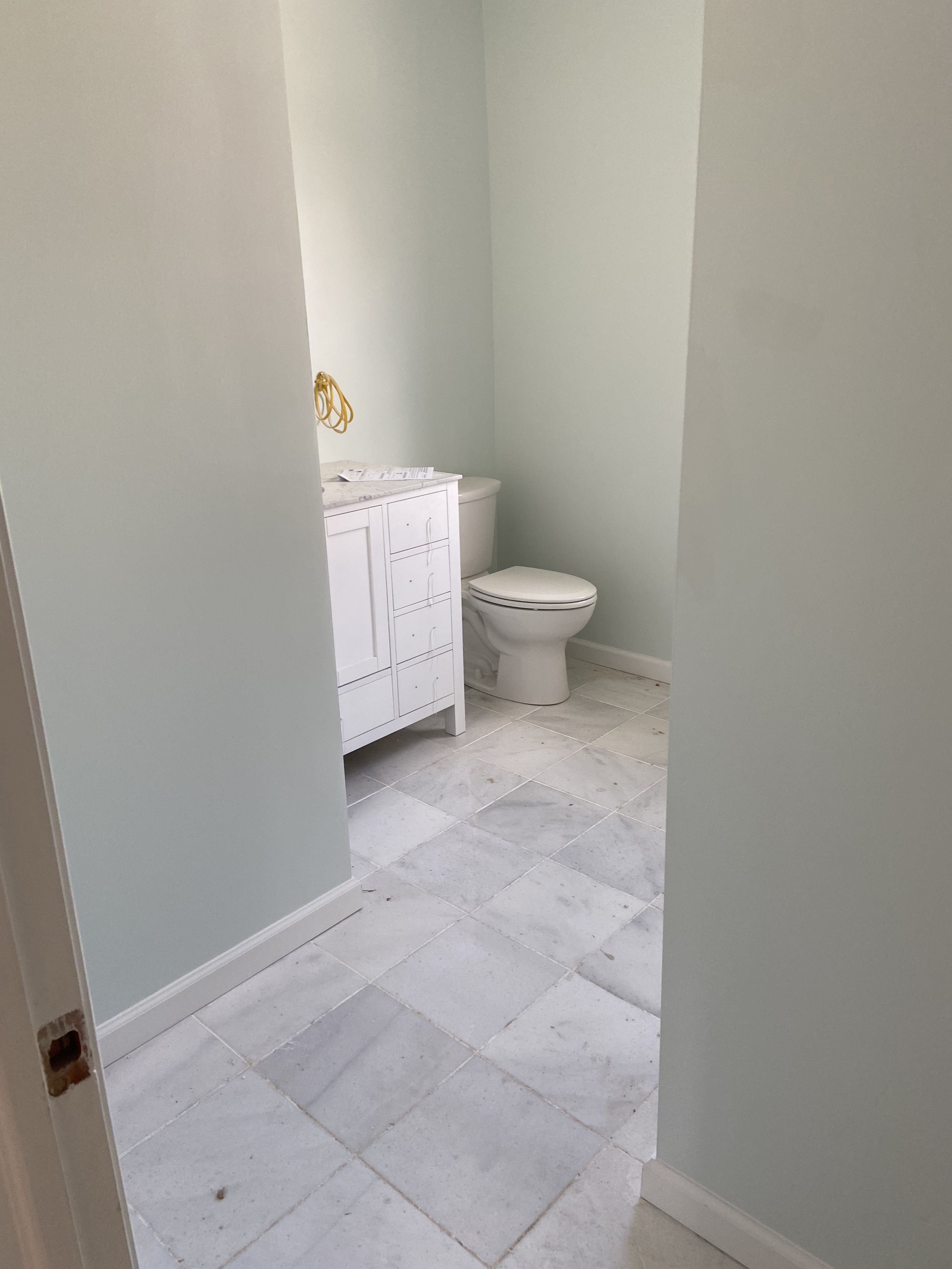 Finished bathroom remodel with marble tile floor, new vanity and fresh paint