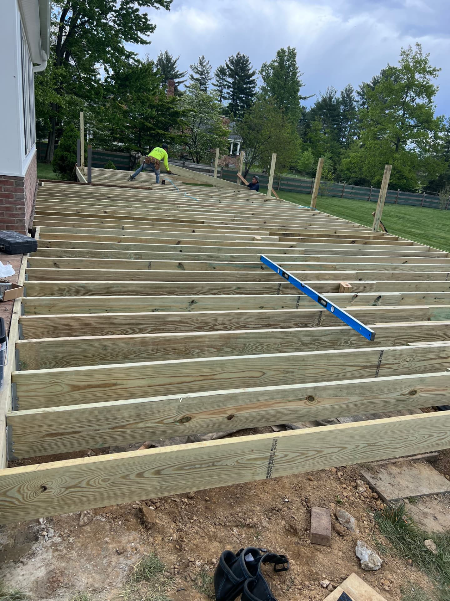 Deck framing in progress with pressure-treated joists being set by Juan Resendiz Contractor